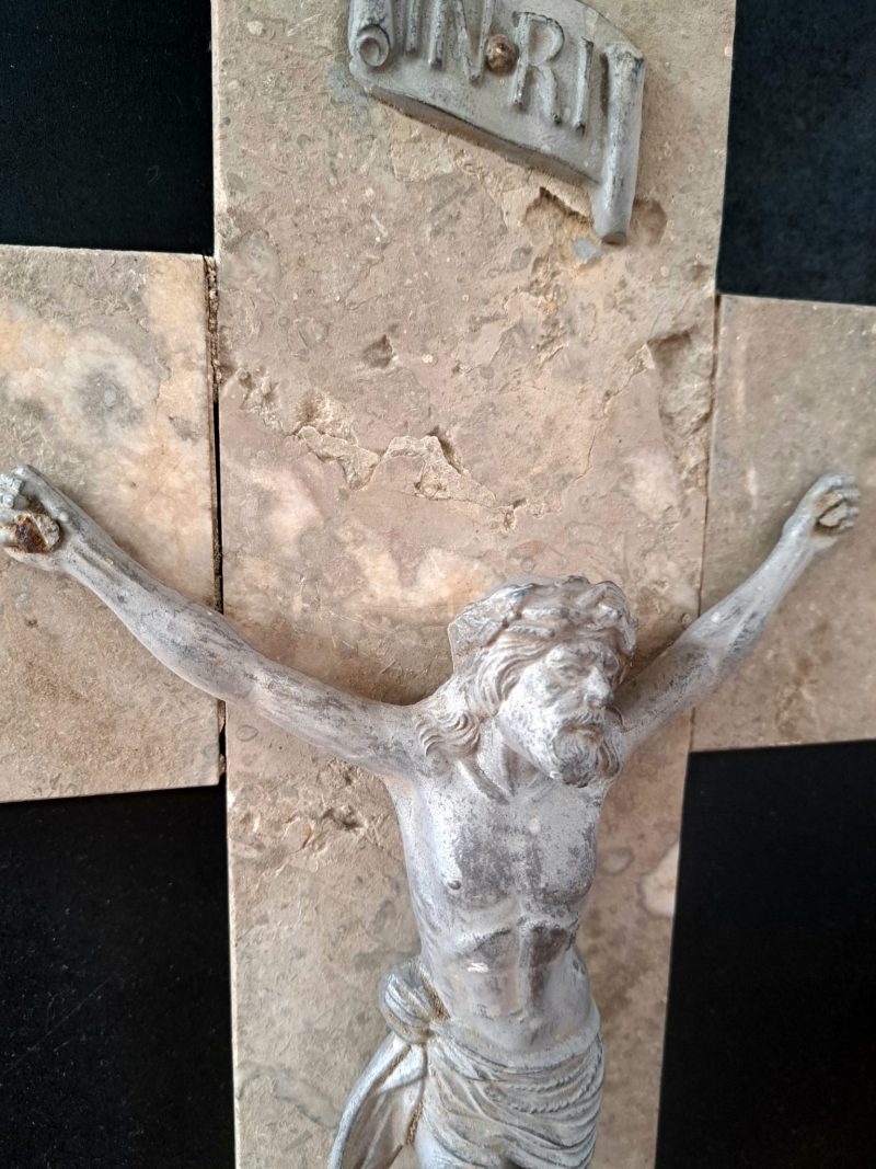 metal jesus christ on marble cross